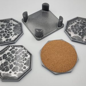 Set of 4 octagonal dark grey coasters and holder with silver pattern table photo